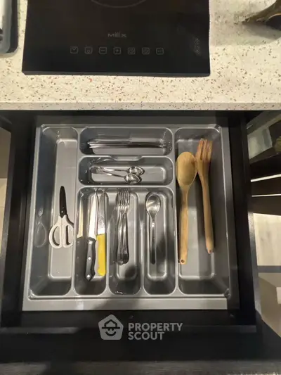 Modern kitchen drawer with organized cutlery and utensils