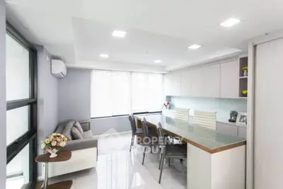 Modern living room with sleek furniture and large windows for natural light.