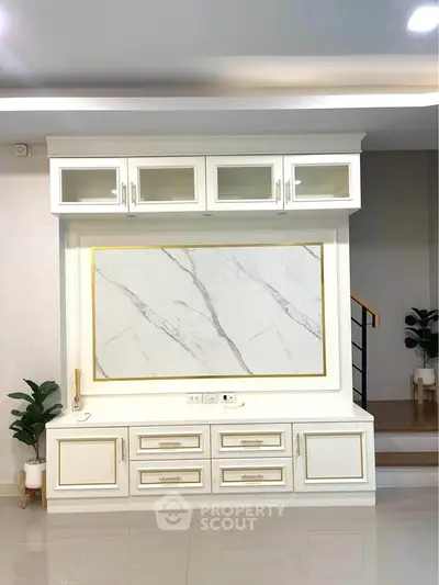 Elegant living room with modern built-in storage and marble accent wall