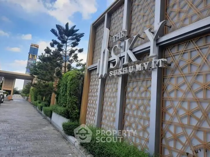 Luxurious entrance of The Sky Sukhumvit with modern architectural design and lush greenery.