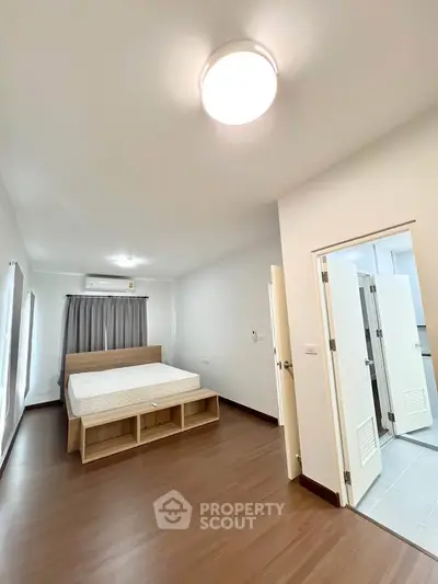 Spacious bedroom with modern design and ample natural light