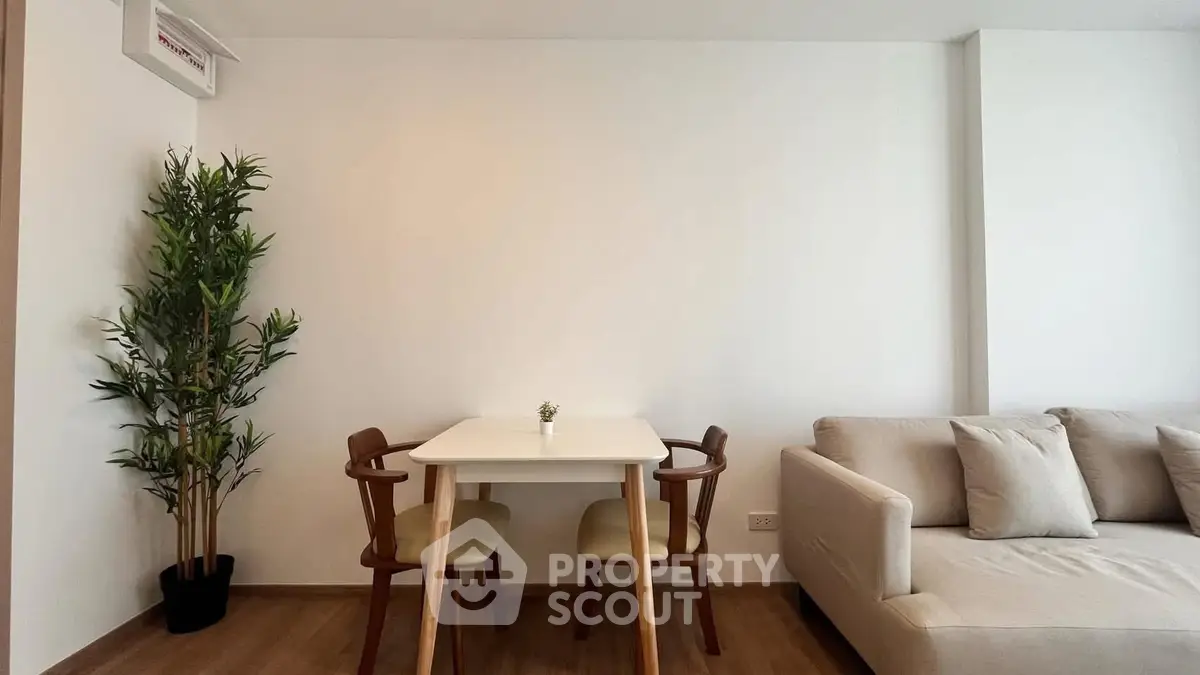 Modern living room with cozy sofa and dining table, perfect for relaxation and entertaining.