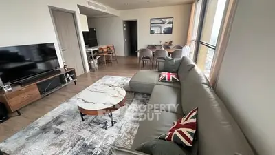 Spacious modern living room with stylish decor and large windows offering natural light.