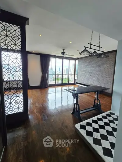 Spacious living room with elegant wooden flooring and large windows offering city views.