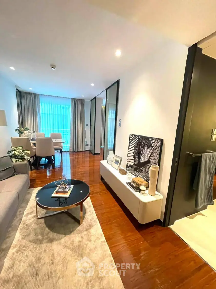 Modern living room with elegant decor and hardwood floors in a stylish apartment.