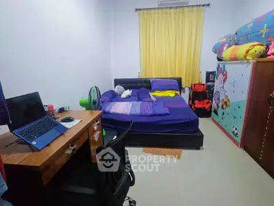 Cozy bedroom with desk and vibrant decor, perfect for a comfortable living space.