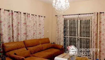 Elegant living room with floral curtains and chandelier