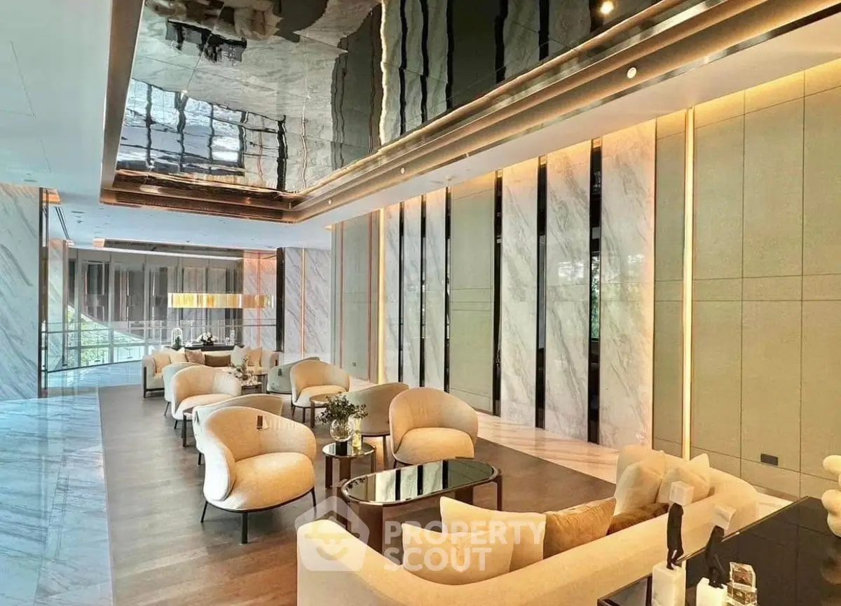 Luxurious modern living room with elegant seating and reflective ceiling design