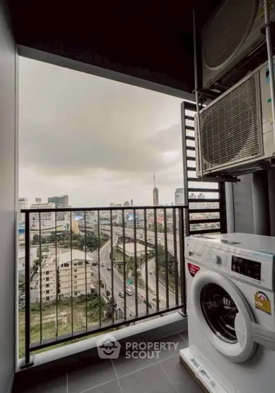 Urban balcony with washing machine and city view, perfect for modern living.
