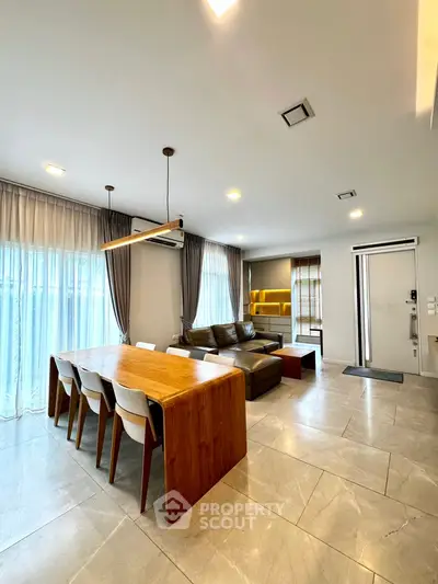 Spacious modern living room with elegant dining area and natural light