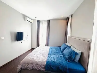 Spacious bedroom with modern decor and natural light