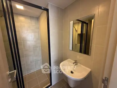 Modern bathroom with sleek shower and elegant sink in a contemporary real estate property.