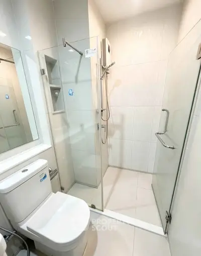 Modern bathroom with glass shower enclosure and sleek fixtures