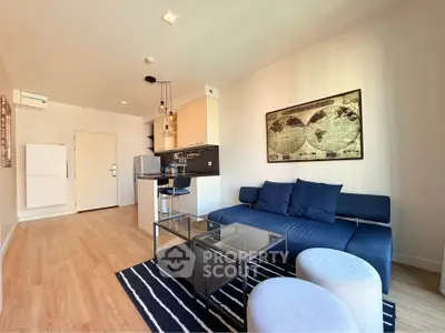 Modern living room with stylish decor, open kitchen, and cozy seating area in a contemporary apartment.