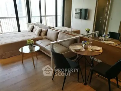 Modern studio apartment with open layout, featuring cozy living area and stylish dining space.