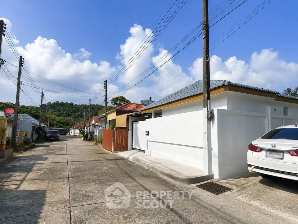 Charming suburban street with modern single-story homes and clear blue skies.