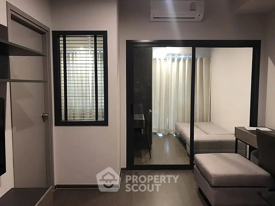 Modern apartment interior with glass partition and cozy furnishings