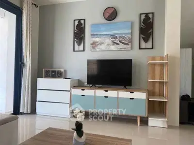 Modern living room with stylish decor and TV unit, perfect for relaxation.