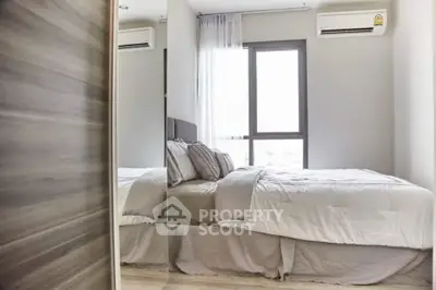 Modern bedroom with large window and air conditioning, featuring a cozy bed and stylish decor.