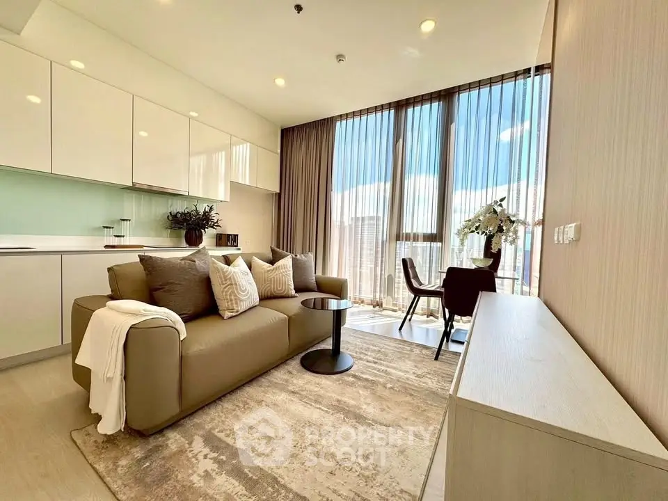 Modern living room with elegant decor and large windows offering city views.