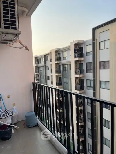 Spacious balcony with city view in modern apartment complex