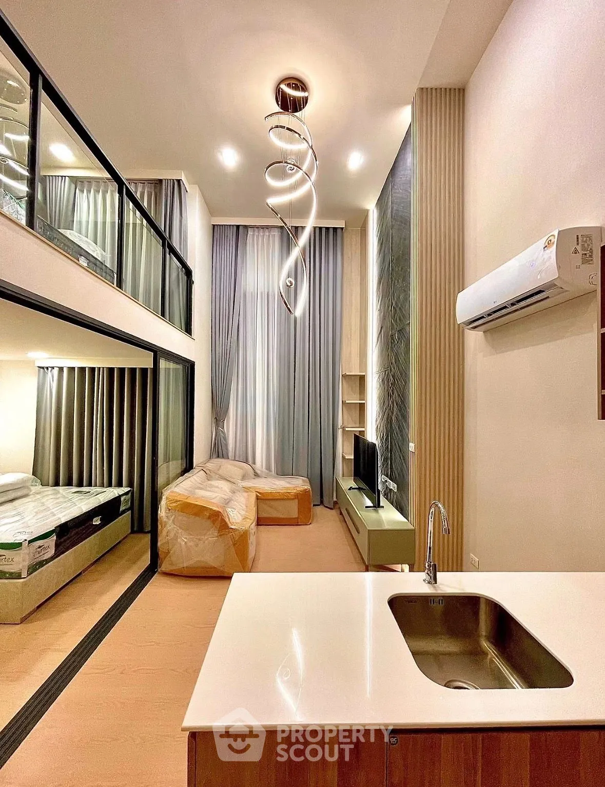 Modern loft apartment with high ceilings, stylish lighting, and open living space.