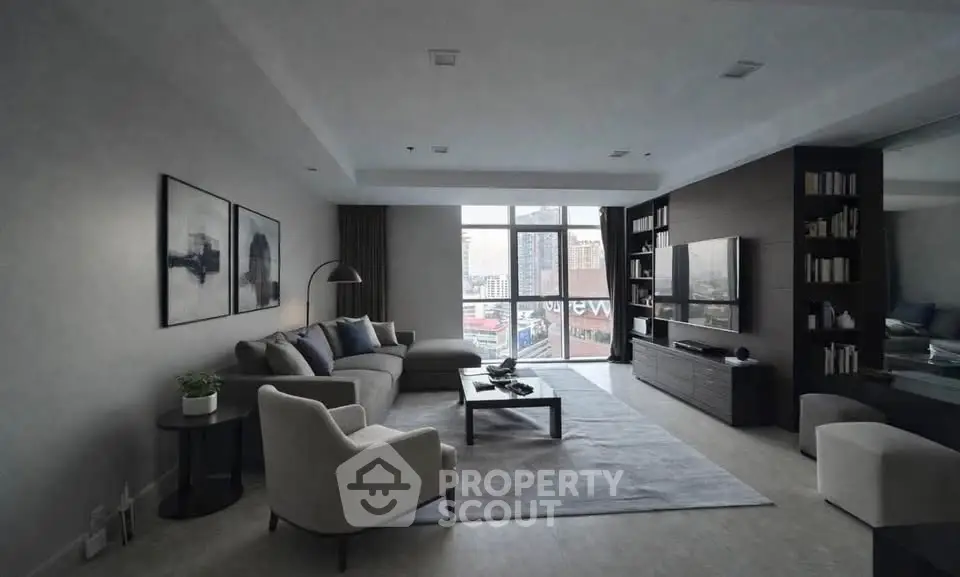 Spacious modern living room with city view, elegant furniture, and stylish decor.
