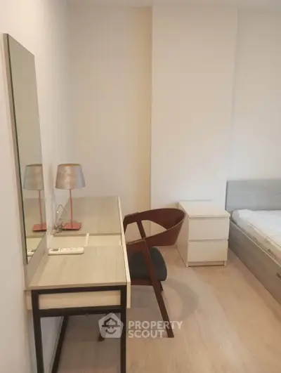Modern bedroom with stylish desk and chair, perfect for a cozy and functional living space.