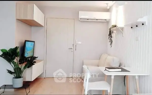 Modern minimalist living room with white sofa, wall-mounted TV, and air conditioning.