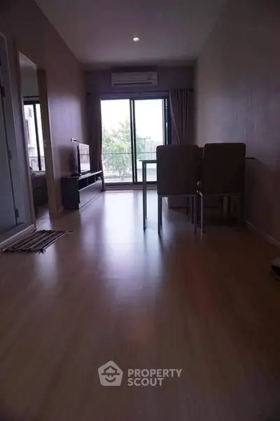 Spacious living room with modern decor and large window view