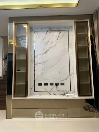 Luxurious modern interior with marble feature wall and elegant built-in shelving