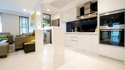 Modern open-layout kitchen and living room with sleek appliances and stylish decor.