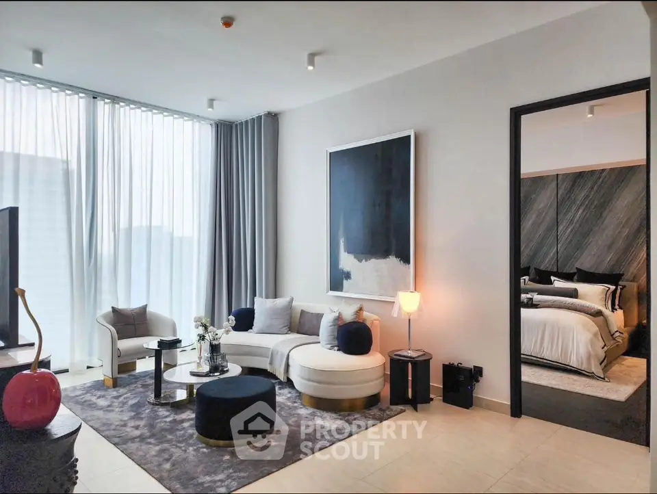 Luxurious modern living room with elegant decor and a glimpse into a stylish bedroom.