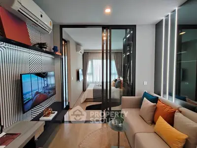 Modern living room with stylish decor and sliding glass doors to bedroom