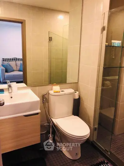 Modern bathroom with glass shower and sleek fixtures in a stylish apartment.