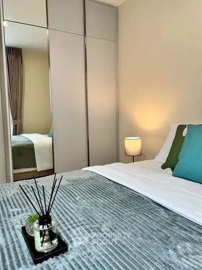 Cozy bedroom with modern decor and ample natural light