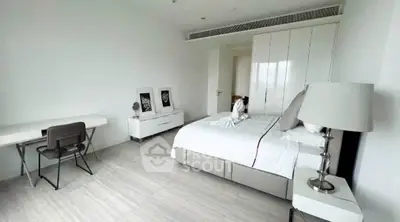 Spacious modern bedroom with elegant decor and ample natural light