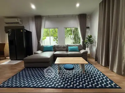 Spacious living room with modern decor and large windows