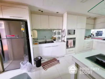 Modern kitchen with sleek white cabinetry and stainless steel appliances