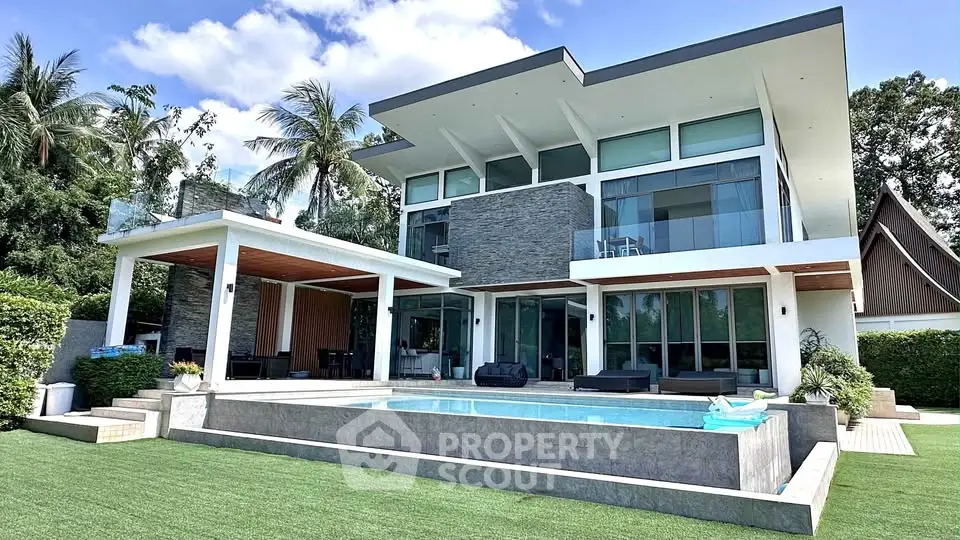 Luxurious modern villa with pool and lush garden, perfect for upscale living.