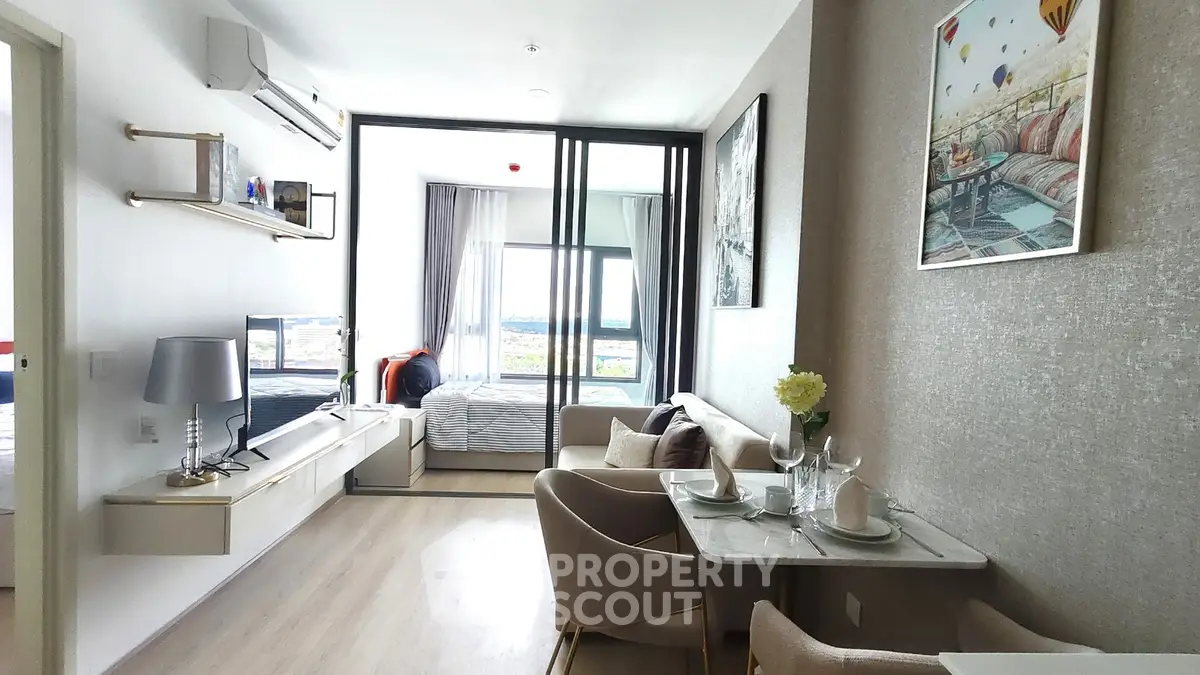 Modern open-plan living room with dining area and balcony view