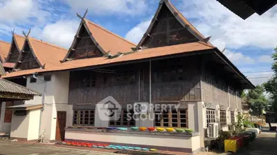 Traditional architectural building with unique roof design and colorful outdoor decor.