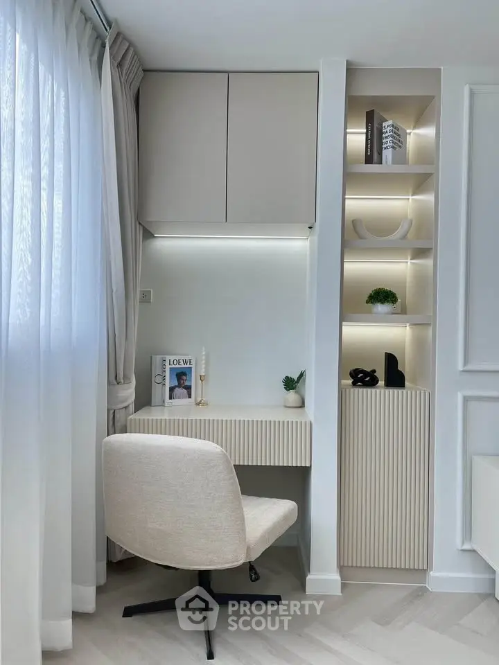 Modern study nook with built-in shelves and elegant decor in a bright room.