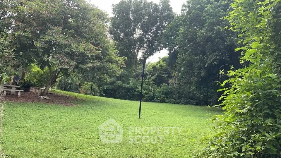 Spacious green garden with lush trees and serene ambiance