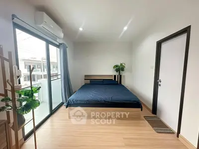 Spacious bedroom with balcony access and modern decor in a stylish apartment.