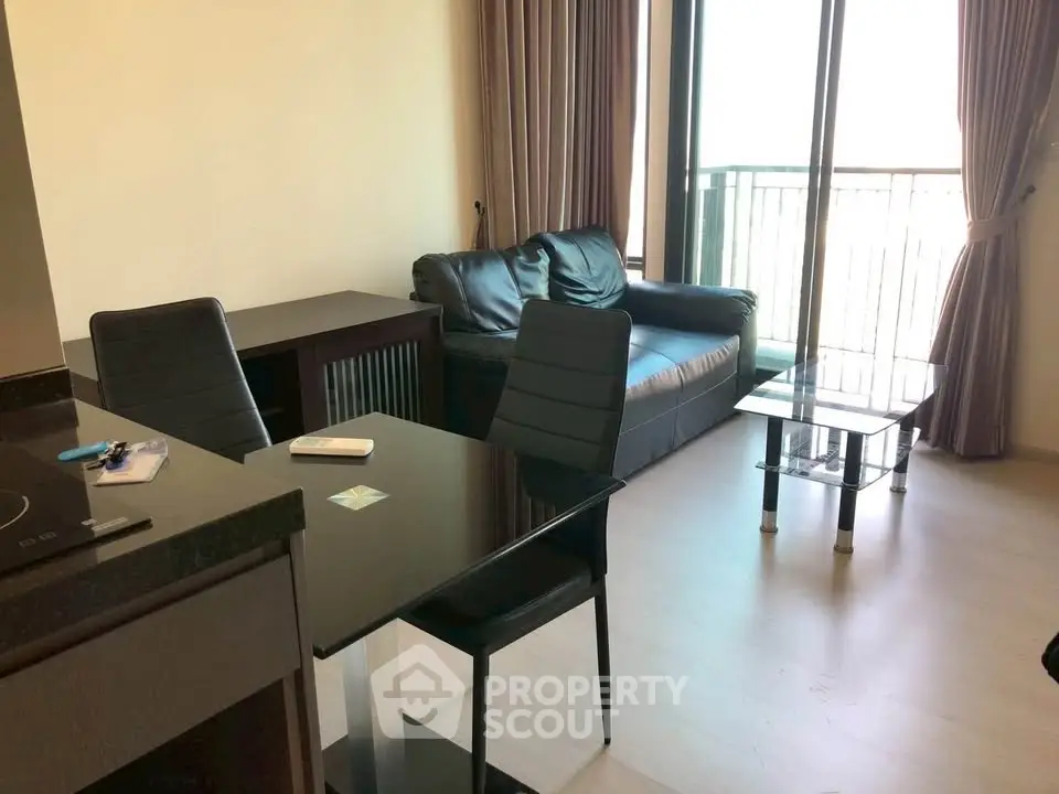 Modern living room with sleek furniture and balcony view, perfect for urban living.