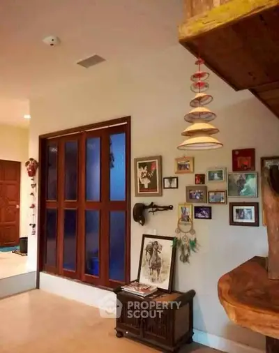 Charming interior with eclectic decor and framed art on walls, showcasing a cozy and inviting atmosphere.