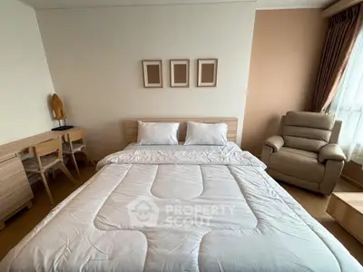 Spacious bedroom with cozy bed, elegant decor, and natural light for a serene living experience.