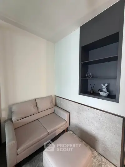 Cozy living room corner with modern sofa and built-in shelving