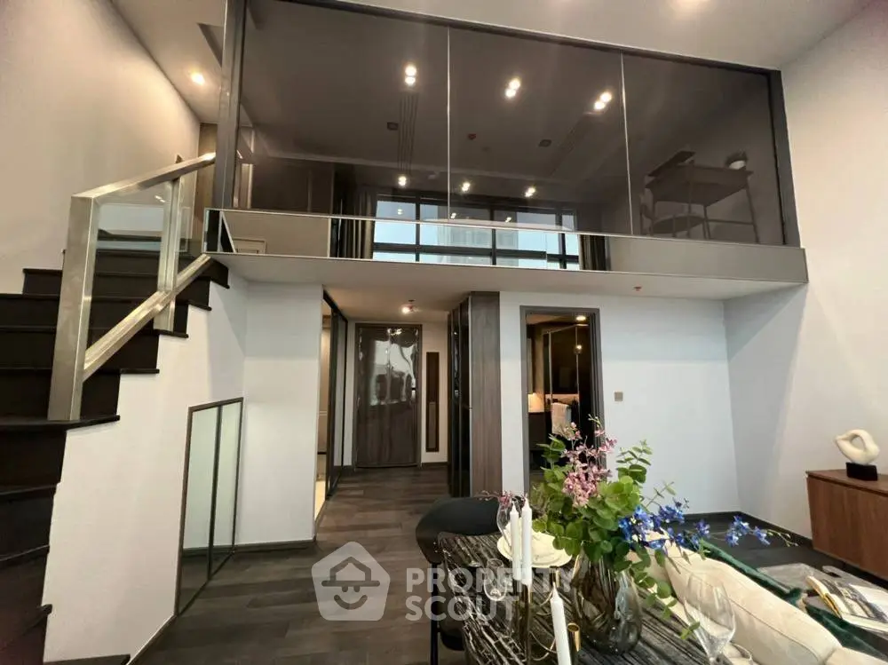 Modern duplex apartment with stylish interior and elegant staircase